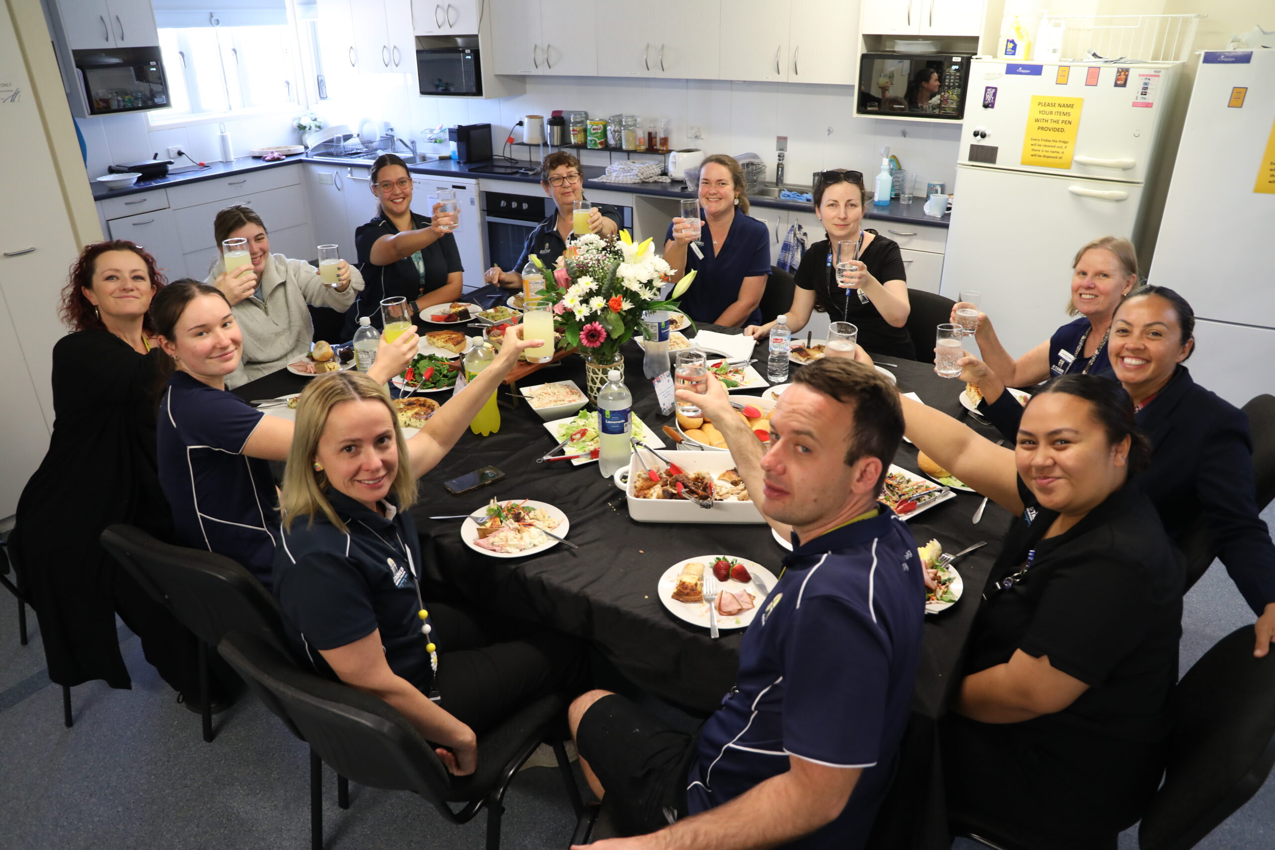 Staines Memorial College staff enjoying a meal together.